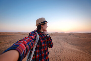 attractive asian young woman in plaid shirt in desert