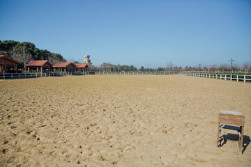A large arena with sand for horses . Elite Horse and Polo Club . training ground. horse club. Sand Stadium for horseback riding. Horse home .
