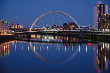 Fototapeta na wymiar Night view of the Clyde Arc or Squinty Bridge from the East and river Clyde, Glasgow, Scotland