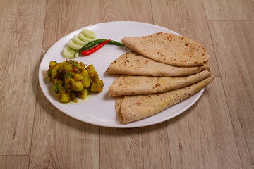 Jeera Aloo chapati - Potatoes Flavoured With Cumin is a hot and spicy accompaniment for curry can be eaten as a snack with bread,parathas,chapati and rice.Shallow depth of field photograph.