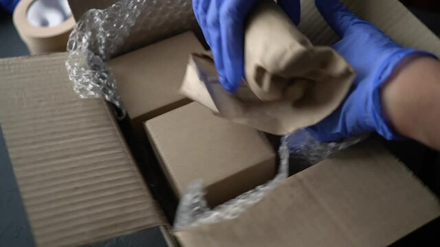 Worker packs cosmetic products. Delivery of cosmetics. Online shopping