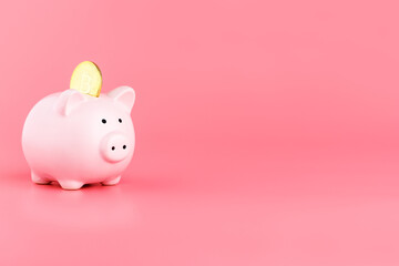 Piggy Bank and bitcoin on a pink background. Bitcoin mining concept