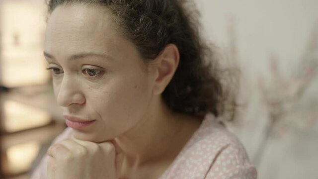 Pensive middle-aged woman crying alone, upset with life troubles, depression
