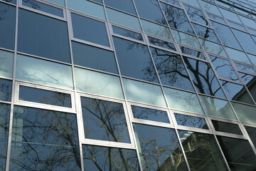 Exterior Windows Of A Modern Commercial Office Building. low angle view of a glass modern facade with reflections