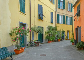 Rue fleurie en Italie avec maisons colorées.