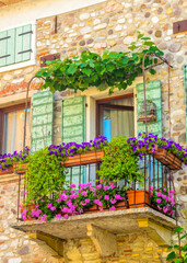 Fototapeta na wymiar Beautiful window decorated with flowers in Italy.