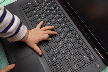 laptop notebook with child hands from above