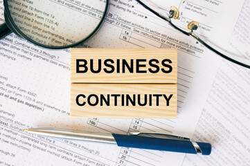 Wooden blocks with text Business Continuity on financial docs