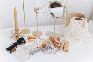 Summer accessories. Gold jewellery, sunglasses, cosmetics, perfume, lingerie, candles, boho mirror