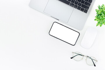 Top view Working space laptop with keyboard , grasses and smartphone isolated on white background with copy space