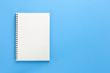 Note book and Eye care paper with copy space isolated on blue background