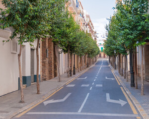 Fototapeta na wymiar Narrow medieval street in Old Sigest town, historical resort-city close to Barcelona city, Spain