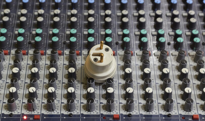 Electrical wall socket. Audio mixer.
