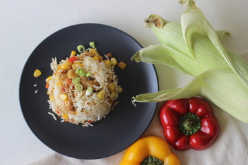 Steamed white rice served with sorted chicken, sweet corn, baby corn, spring onions and bell peppers.