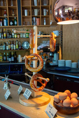 German pretzels hanging on a rack in a cafe next to boiled eggs in Bavaria. 