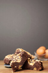 Cocoa donuts with almonds and nuts in a black and brown background vertical
