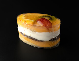 Appetizing fruit cake, on a black background, isolated