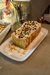 Homemade Moist Lemon Vegan Pound Cake or Loaf sliced with icing on a dish
