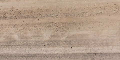 view from above on car tire tracks on texture of gravel road