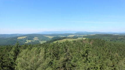 Fototapeta na wymiar A view to the landscape with forests and rocks from the lookout tower Cap near Skaly, Czech republic