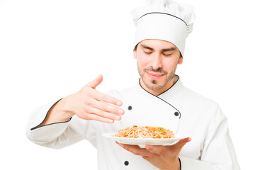 Professional chef holding a plate of spaghetti