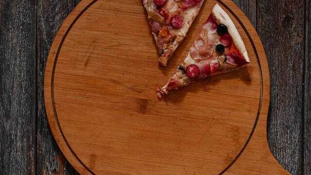 Disappearing pizza hands taking all the pieces. Stop motion pizza animation