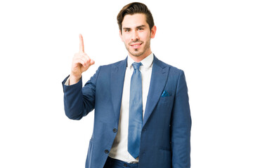 Young man in a suit standing in front of a white background