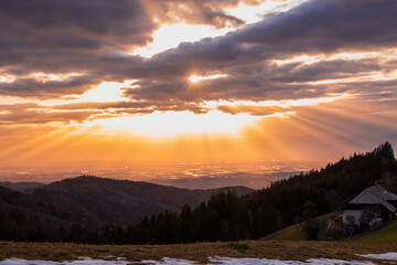 The marvelous sunset over the Rhein (Rhine) valley. The rays of the sun through the clouds. Black Forest, Germany