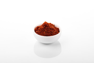 Korean hot pepper flakes. Pepper flakes in white bowl, on white background