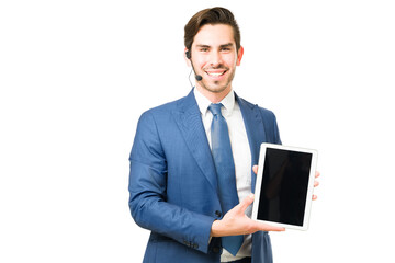 Attractive man pointing to a blank screen of a tablet