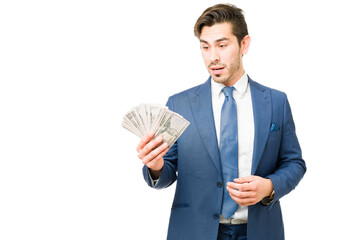 Professional man in a suit holding a lot of money