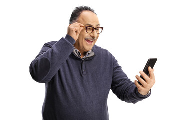 Excited mature man with glasses looking at a smartphone