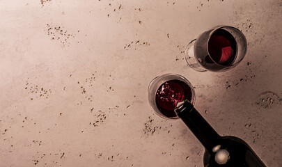 Red wine tasting - pouring alcohol from the bottle into two glasses