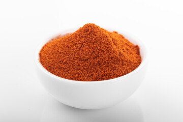 Red hot pepper powder. Pepper powder in white bowl, on white background