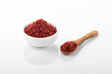 Chili pepper flakes. Chili pepper flakes in white bowl, on white background.