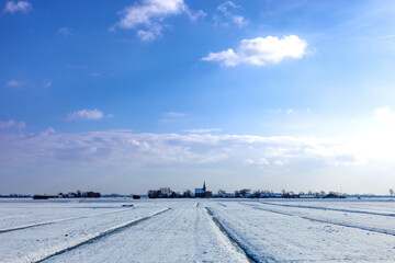 Landscape with church and village 't Woudt (wood) in The Netherlands close to Delft in Westland, in winter.