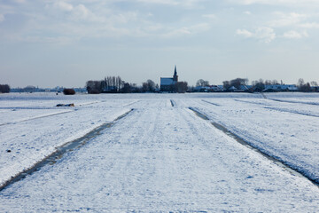 Landscape with church and village 't Woudt (wood) in The Netherlands close to Delft in Westland, in winter.