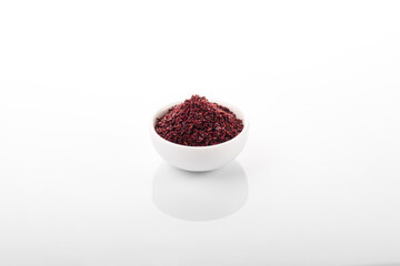 Sumac. Sumac spice in white bowl, on white background. Sumac, sumac flakes