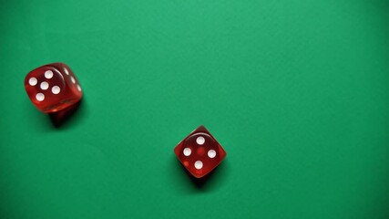 Red dice falling on green table. The Numbers 5 and 4 Appear on the Dice. - Powered by Adobe