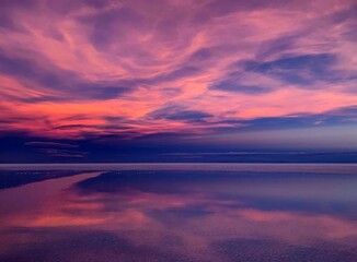 Sunset sky purple clouds  shiny sea reflection. Divine sunset heaven. Magical alien landscape of planet. Space Martian nature. Mysterious lake horizon. Incredible desert view.