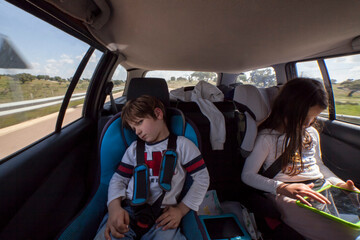 Angry 5 years old boy inside the car