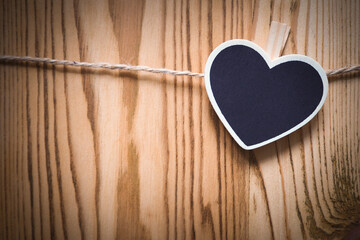 Wooden heart-shaped  nameplate on a rope, background - 426193362
