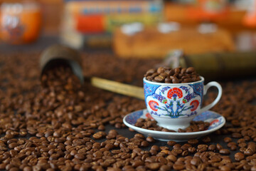 Turkish coffee concept. Copper pot (Cezve), vintage coffee grinder, coffee beans on a dark wooden background. Arab Turkish east coffee top view on dark wood background