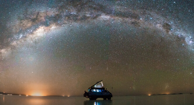 Milky way in the Salar of Uyuni, car silhouette