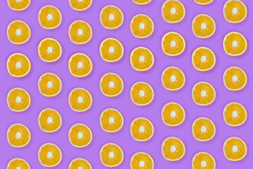 Pattern of fresh slice oranges on purple background