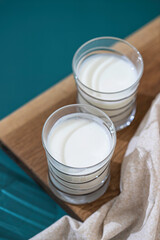 Fermented drink kefir, yogurt in a glass jar on a light background. Probiotic cold fermented dairy drink. Healthy gut flora concept.