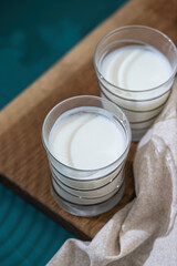 Fermented drink kefir, yogurt in a glass jar on a light background. Probiotic cold fermented dairy drink. Healthy gut flora concept.