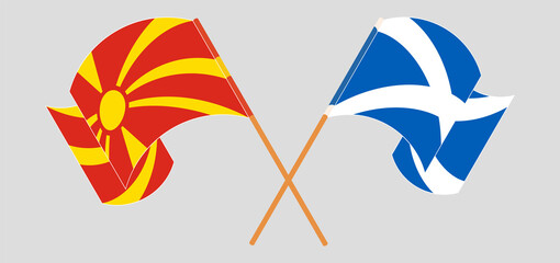 Crossed and waving flags of North Macedonia and Scotland
