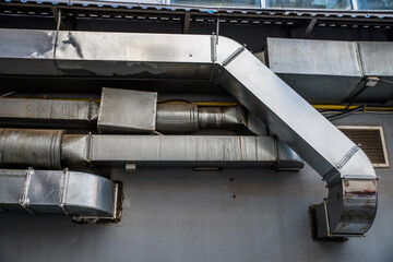 Ventilation pipes on the wall of the house.
