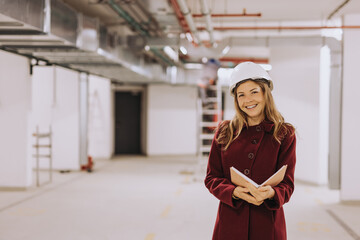 Portrait of a quality control inspector at factory hall.